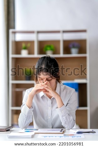 Asian women are stressed while working on laptop, Tired asian businesswoman with headache at office, feeling sick at work, copy space Royalty-Free Stock Photo #2201056981