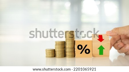Interest rate hike and Finance banking economic policy concept. Money coin and Wooden blocks with Icon percentage and arrow. Royalty-Free Stock Photo #2201065921
