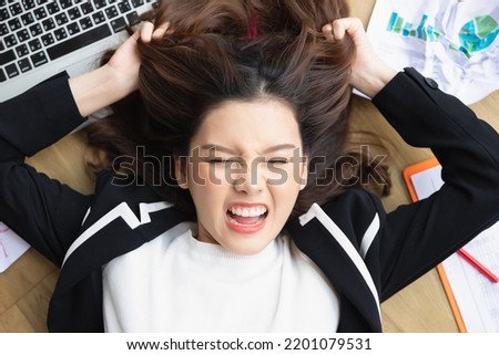 Top view beautiful young asian businesswoman feeling tired from work in the office. Portrait of a casual stressed lady with a headache at desk, an Exhausted businesswoman.