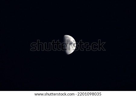 Close up of half moon over Joshua Tree national park. Beautiful sharp image of moon with black background. Night sky photography over south Californian desert.