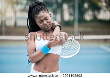 Injury, pain and elbow of tennis woman player with sad, hurt or crying emotion during match, game or training outdoor. Sports fitness athlete person with bone health stress or medical sport emergency Royalty-Free Stock Photo #2201102603