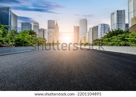 Straight asphalt road and modern city skyline with buildings in Guangzhou at sunset, China. Royalty-Free Stock Photo #2201104895