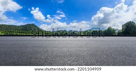 Asphalt road and green forest with mountain nature landscape