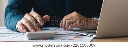 Businessmen analysts conduct company financial audits, read and write company performance reports, business planning and strategies to maximize sales profits, banner size image. Royalty-Free Stock Photo #2201105309
