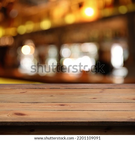 Empty wooden surface against blurred background. Space for design