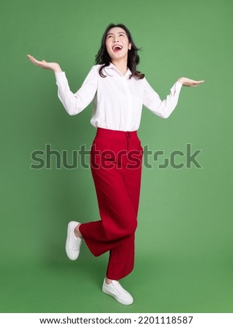 Full length photo of young Asian woman on background