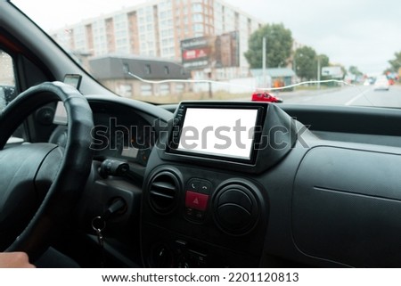 View from inside a car on a part of the dashboard with a navigation system. Mockup. Copyspace. Front. Indoors. Mirror. Multimedia. Music. Panel. Race. Travel. Motion. Map. Radio. Volume. System. Trip Royalty-Free Stock Photo #2201120813