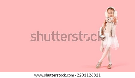 Cute little girl in winter clothes and with ice skates on pink background with space for text