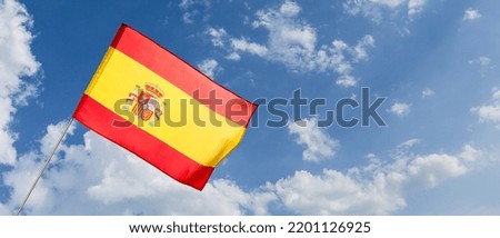 Waving flag of Spain against blue sky