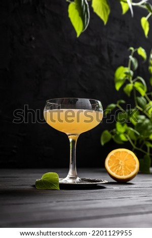 Gold rush sour cocktail with bourbon or whisky, lemon juice and honey sirup served in a coupe glass on dark background Royalty-Free Stock Photo #2201129955