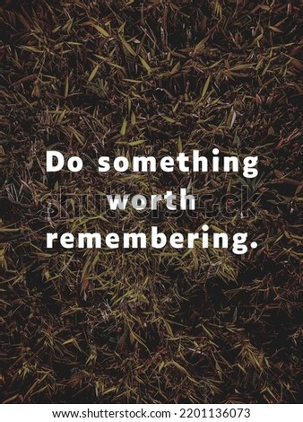 Motivational quote "Do something worth remembering." in dark grass background