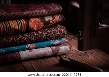 A stack of traditional Indonesian batik fabric Royalty-Free Stock Photo #2201142931