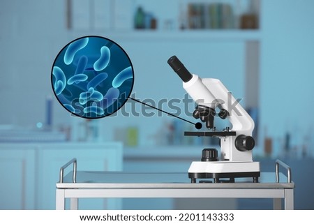 Examination of sample with bacteria under microscope in laboratory Royalty-Free Stock Photo #2201143333