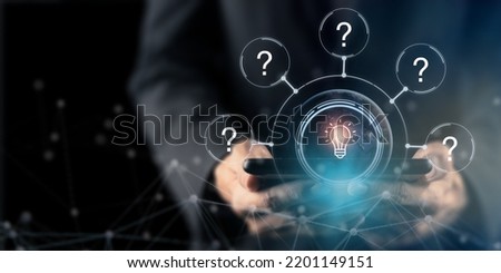 Question marks and light bulb symbolizing idea or solution. Problem solving skill, creativity, innovation, brainstorming, critical thinking and root cause analysis concept. Question, idea and answer. Royalty-Free Stock Photo #2201149151