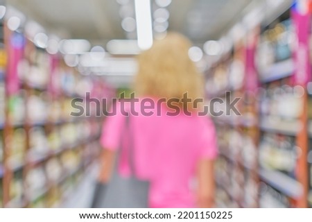 Woman silhouette on abstract blurred supermarket background with rows of shelves with drinks, idea for postcard or website design. Mockup for a banner in the office or advertising