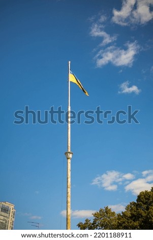 Ukrainian flag in the wind on blue sky background. Large national yellow blue flag of Ukraine. 