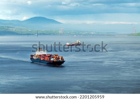 Container ships on St Lawrence river in Quebec, Canada Royalty-Free Stock Photo #2201205959