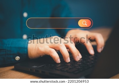 Freelance's hand working with computer laptop on desk in home. Searching Browsing Internet Data Information with blank search bar. Search Engine Optimization SEO Networking Concept.