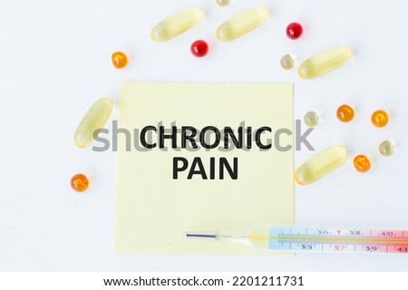 Chronic pain -Diagnosis written on a white piece of paper. Treatment and prevention of disease. Syringe and vaccine with drugs. Medical and Healthcare concept. Selective focus