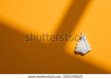 Gypsum figure of a Christmas tree on a colored background