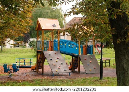 An empty kids' playground in the autumn park of Serbia Royalty-Free Stock Photo #2201232201
