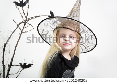 Halloween studio portrait of cute 4 years old girl.	