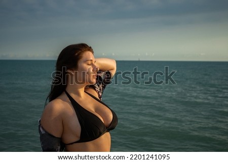Girl with dark hair at sea