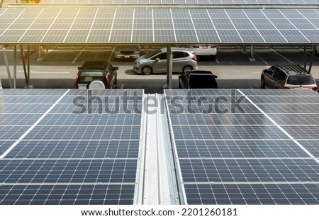 Solar Panel Photovoltaic installation on a Roof of car parking lot, alternative electricity source - Sustainable Resources Concept.
