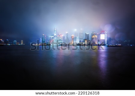 night view at shanghai china, huangpu river and bund.blur in the rain.