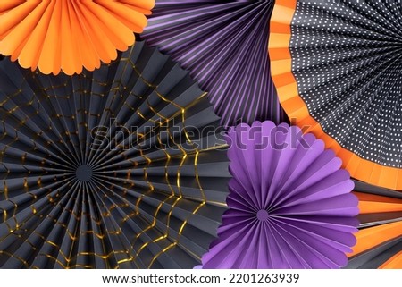 Paper Fans Halloween decoration. Halloween composition with round colorful paper fans. Black, purple and orange round paper fans backgrounds.