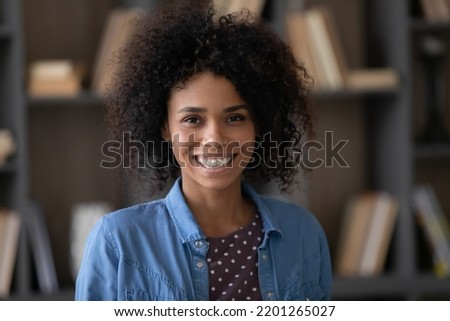 Head shot portrait of happy millennial confident African American businesswoman worker employee looking at camera, profile photo for professional social network, corporate career, female leadership.