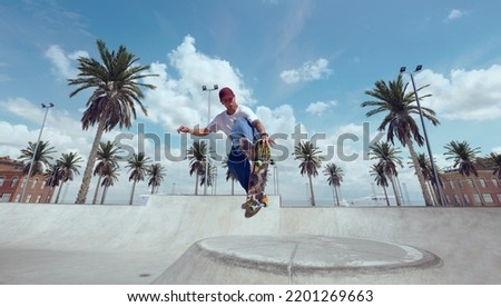 Skateboarder doing a trick in a skate park Royalty-Free Stock Photo #2201269663