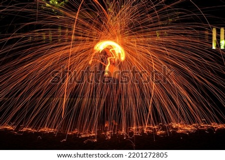 Light painting at night with fire