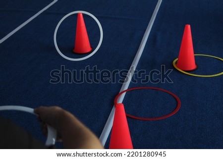 Some throw rings to red cones. Game for children . High quality photo Royalty-Free Stock Photo #2201280945
