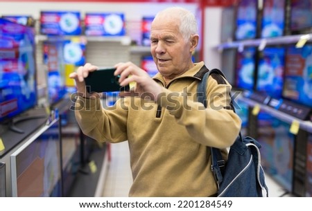 elderly grayhaired man pensioner takes a photos