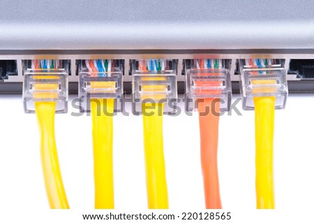 Part of lan ethernet switch with five network cables plugged in. Isolated on white background.