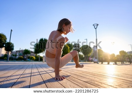 Young woman doing exercise outdoor animal flow innovative movement. Young caucasian woman doing workout at sunrise Royalty-Free Stock Photo #2201286725