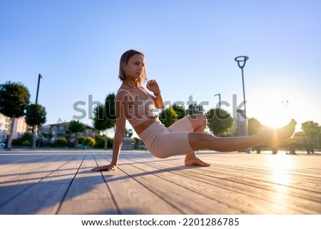 Young woman doing exercise outdoor animal flow innovative movement. Young caucasian woman doing workout at sunrise Royalty-Free Stock Photo #2201286785