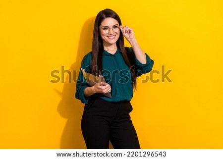 Photo of young pretty woman expert hold tablet corporate marketer attorney isolated over yellow color background