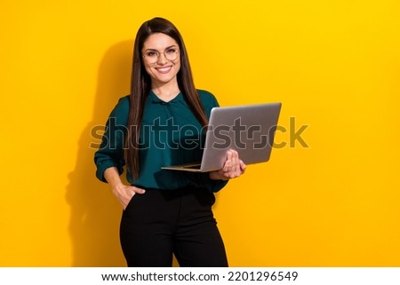 Photo of young pretty woman hold laptop project representative marketer isolated over yellow color background