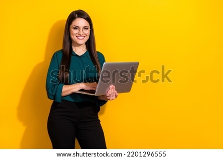 Photo of cute sweet woman wear green shirt spectacles typing modern device empty space isolated yellow color background
