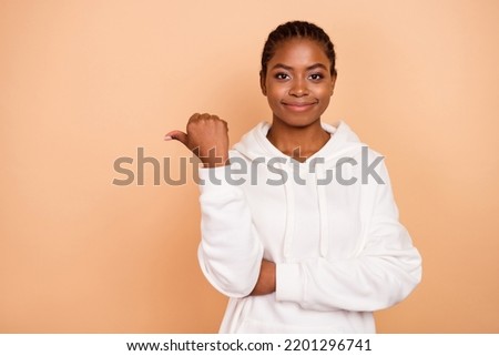 Photo of nice young brunette lady index promo wear white hoodie isolated on beige color background