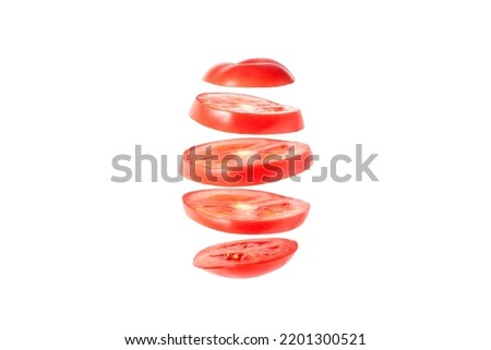 Levitation of tomato slices - isolated tomato slices float in the air Royalty-Free Stock Photo #2201300521
