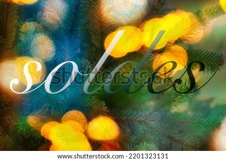 a background picture of festive bokey blurry christmas lights during the holiday season and french sale sign