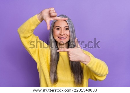 Photo of cute positive mature grandma take picture of you catching memorable moment isolated on purple color background