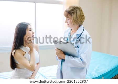 Beautiful Asian woman consulting a cosmetologist for cosmetic surgery in a clinic.