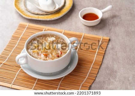 Shark fin soup (Indonesia : Soup Sirip Ikan Hiu) is a popular soup in Chinese cuisine which is usually served on special occasions such as weddings or banquets. Royalty-Free Stock Photo #2201371893