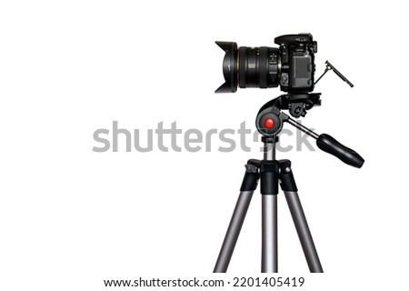 Digital camera with lens hood on tripod isolated on white background with copy space