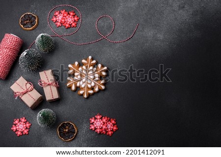 Christmas decorations and gingerbreads on a dark concrete table. Preparing and decorating the house for holiday