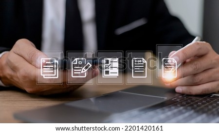 Paperless workplace ideas, e-signing, electronic signature, document management. A businessman signs an electronic document on a digital document on a virtual screen.